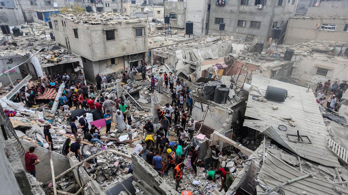 آتش‌بس غزه People search through buildings destroyed during Israeli air raids in the southern Gaza Strip on Oct. 29.Photographer: Ahmad Hasaballah/Getty Images